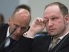 Norwegian Anders Behring Breivik, right, who is facing terrorism and premeditated murder charges, reacts as a video presented by the prosecution is shown in court, Oslo, Norway, Monday, April 16, 2012. Breivik, who confessed to killing 77 people in a bomb-and-shooting massacre went on trial in Norway's capital Monday, defiantly rejecting the authority of the court. At left is defence lawyer Geir Lippestad. (AP Photo/Heiko Junge, Pool)