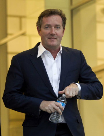 FILE- This Tuesday, Dec. 20, 2011 file photo shows Piers Morgan, host of CNN's "Piers Morgan Tonight," as he leaves the CNN building in Los Angeles. Morgan was in the position few television interviewers like to be this week: on the other side of the microphone. He testified via video link about his past life as a London tabloid editor before a British panel looking into media ethics after the phone hacking scandal. (AP Photo/Jae C. Hong, FILE)
