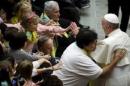 Pope Francis blesses people during a special audience for members of Opera Don Guanella at the Paul VI Hall at the Vatican