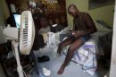 In this July 20, 2012 photo, professional dancer Georges Exantus prepares to put on his prosthetic limb in his bedroom as he prepares for his wedding in Port-au-Prince, Haiti. Exantus thought he'd never dance again. The earthquake three years ago in Haiti's capital flattened the apartment where he was living, where he spent three days trapped under a heap of jagged rubble. After friends dug him out, doctors amputated his right leg just below the knee. Israeli doctors and physical therapists who came to Haiti after the quake sent him to Israel for surgery and rehabilitation. Three years later, the 32-year-old professional dancer is back on the floor, spinning away as he does the salsa, cha-cha and samba. (AP Photo/Dieu Nalio Chery)