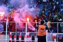 Fans use flares and shout slogans during a football match on April 6, 2013 at the stadium in Kinshasa