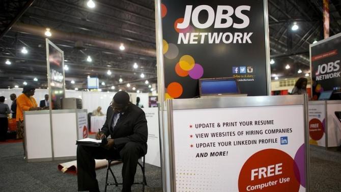 Job-seeker completes an application at a career fair held by civil rights organization National Urban League as part of its annual conference, in Philadelphia