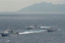 Chinese marine surveillance cruises next to Japan Coast Guard patrol ships in the East China Sea, known as the Senkaku isles in Japan and Diaoyu islands in China