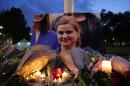 Floral tributes and candles are placed by a picture of slain Labour MP Jo Cox at a vigil in Parliament square in London on June 16, 2016