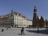 Tourists walk through the main square with the Town Hall on the right in Wroclaw, Poland, in this  Aug. 18, 2011 photo. The latest backdrop for European financial crisis talks was Wroclaw, Poland _ or Breslau, as the picturesque city on the Oder River is still known in Germany. As Europe's finance chiefs bounce from meeting to meeting trying to hash out a strategy to contain their debt troubles, the city's history may serve as a reminder of what is at stake: a hard-won European unity that followed centuries of ravaging wars and has slowly enveloped the former Communist states in the continent's east.  (AP Photo/Czarek Sokolowski)