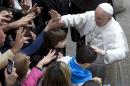 Pope Francis greets faithful as he arrives for a meeting with relatives of innocent mafia victims, in Rome's St. Gregorio VII church, just outside the Vatican, Friday, March 21, 2014. (AP Photo/Andrew Medichini)