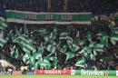 Celtic fans hold up team flags in the stands during the UEFA Champions League group stage football match between Celtic and Barcelona at Celtic Park in Glasgow on November 23, 2016