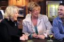 Camilla, The Duchess of Cornwall (L) meets actress Anne Kirkbride (C) during a visit to the Rovers Return Pub on the set of British television soap opera 'Coronation Street', in Manchester on February 4, 2010