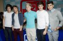 FILE - In this March 12, 2012 file photo, One Direction band members Harry Styles, from left, Louis Tomlinson, Niall Horan, Liam Payne and Zayn Malik attend a CD signing at J&R Music World in New York. One Direction's debut album 
