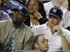 Miami Heat's Dwayne Wade, left, sits beside New York Jets quarterback Tim Tebow during the New York Yankees baseball game against the Los Angeles Angels at Yankee Stadium in New York, Sunday, April 15, 2012. (AP Photo/Kathy Willens)
