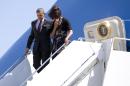 President Barack Obama and first lady Michelle Obama get off Air Force One upon their arrival at Robert Gray Army Air Field in Killeen, Texas, Wednesday, April 9, 2014, before traveling to Fort Hood for a memorial service for those killed there in a shooting last week. (AP Photo/Carolyn Kaster)
