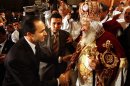 FILE - In this Thursday, Jan. 6, 2005 file photo, Egyptian President Hosni Mubarak's son, Gamal Mubarak, left, congratulates Pope Shenouda III, the head of the Coptic Orthodox Church, marking the Egyptian Christmas which falls on Friday on Egypt's Coptic Christian calendar, after the Pope delivered the sermon at the midnight mass in the Abbassiya cathedral. Pope Shenouda III, the patriarch of the Coptic Orthodox Church who led Egypt's Christian minority for 40 years during a time of increasing tensions with Muslims, has died. He was 88. (AP Photo/Amr Nabil)
