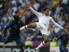 English defender Joleon Lescott (right) rises above French midfielder Alou Diarra to score