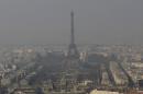 The Eiffel Tower, is barely seen through the smog from Paris, Friday, March 14, 2014. Air pollution that has turned Paris skies a murky yellow is giving a break to millions of French travelers ó all public transportation in the Paris region and two other cities is free for the next three days. Nearly three-quarters of France is under alert in what the European Environment Agency says is the worst air pollution since 2007. (AP Photo/Jacques Brinon)