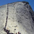 In this 2006 photo provided by the National Park Service, tourists climb Half Dome at Yosemite National Park, Calif. A climb up Half Dome was once only for the most seasoned outdoors people, but in recent years tourists and weekend warriors have been scaling the steep granite slope with the aid of steel cables. When daily traffic on the route reached 1,200 in 2009 and hikers routinely backed up like cars at rush hour, park officials realized something had to be done.  (AP photo/National Park Service)
