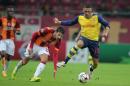 Arsenal's Alex Oxlade-Chaberlain, right, and Hakan Balta of Galatasaray fight for the ball during their Champions League Group D soccer match at the Turk Telekom Arena Stadium in Istanbul, Turkey, Tuesday, Dec. 9, 2014. (AP Photo)
