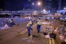 Workers sweep a road after police cleared the main pro-democracy protest site in the Admiralty district in Hong Kong on December 11, 2014