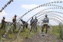 The South Africa contingent of the U.N. peacekeepers in Congo erect a razor wire barrier around Goma airport