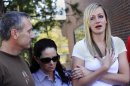 Lindgren, girlfriend of Alex Teves, speaks as Alex's parents, Tom Teves and his wife Caren, listen during an interview after the preliminary hearing for Colorado shooting suspect Holmes, at the Arapahoe County Courthouse in Centennial