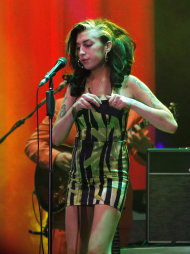 FILE - In this June 18, 2011 file photo, Amy Winehouse performs on stage during her concert in Belgrade, Serbia. British police say singer Amy Winehouse has been found dead at her home in London on Saturday, July 23, 2011. The singer was 27 years old. (AP Photo/File)