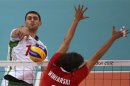 Bulgaria's Tsvetan Sokolov (L) spikes the ball against Poland's Michal Winiarski during their men's Group A volleyball match at the London 2012 Olympic Games at Earls Court
