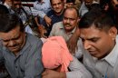 Police escort the juvenile accused in the December 2012 gang-rape of a student, to a court in New Delhi, August 31, 2013