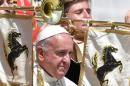 Pope Francis poses with a band at the end of his weekly general audience in Vatican