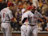 Cincinnati Reds' Brandon Phillips, right, gets congratulated by Drew Stubbs after Phillips hit a two-run home run in the third inning of Game 1 of the National League division baseball series against the San Francisco Giants in San Francisco, Saturday, Oct. 6, 2012. (AP Photo/Eric Risberg)