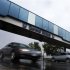 Cars pass under an overpass at the General Motors Car assembly plant in Oshawa