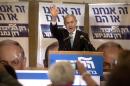 Israeli Prime Minister and Likud party leader Benjamin Netanyahu waves as he delivers a speech during an election campaign meeting at a Jerusalem hotel on February 8, 2015