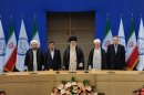 In this photo released by the official website of the Iranian supreme leader's office, supreme leader Ayatollah Ali Khamenei, center, parliament speaker Ali Larijani, right, chief of Expediency Council, Akbar Hashemi Rafsanjani, second right, President Mahmoud Ahmadinejad, second left, and judiciary chief Sadeq Larijani, left, listen to Iran's national anthem, at the start of the Nonaligned Movement, NAM, summit, in Tehran, Iran, on Thursday, Aug. 30, 2012. (AP Photo/Office of the Supreme Leader)