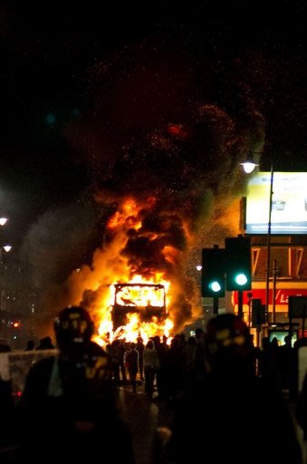 A double decker bus burns on a main road in Tottenham