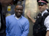 Alleged renegade UBS trader Kweku Adoboli, center, walks to be taken away in a security van flanked by police officers after appearing at the City of London Magistrates Court in London, Friday, Sept. 16, 2011. The alleged renegade trader accused of losing Swiss bank UBS about $2 billion in unauthorized trading was ordered held in prison custody Friday charged with fraud and false accounting. Adoboli, 31, will be held until another court appearance on Sept. 22, presiding magistrate Carolyn Wagstaff said. (AP Photo/Matt Dunham)