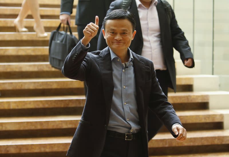 Alibaba founder Jack Ma gives a thumbs up as he arrives to speak to investors at an initial public offering roadshow in Singapore