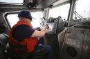 This photo taken Jan. 28, 2014, shows a Coast Guard officer following traffic on his screen while facing a dense fog which is almost completely eliminating visibility during a patrol off the San Diego coast in San Diego. With the drug war locking down land routes across Latin America and at the U.S. border, smugglers have been increasingly using large vessels to carry multi-ton loads of cocaine and marijuana hundreds of miles offshore, where the lead federal agency with extensive law enforcement powers is the Coast Guard, a military service roughly the size of the New York Police Department. (AP Photo/Lenny Ignelzi)