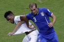 England's Daniel Sturridge, left, and Italy's Giorgio Chiellini challenge during the group D World Cup soccer match between England and Italy at the Arena da Amazonia in Manaus, Brazil, Saturday, June 14, 2014. (AP Photo/Themba Hadebe)