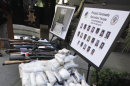 FILE - In this Oct. 22, 2009 file photo, weapons and drugs seized in special joint operation conducted with the Drug Enforecement Administration against the La Familia drug cartel based out of Michoacan, Mexico and operating in San Bernardino and surrounding counties, are on display at a news conference at sheriff's headquarters in San Bernardino, Calif. Drug cartels have long been the nation’s No. 1 supplier of illegal drugs, but in the past, their operatives rarely ventured beyond the border. A wide-ranging Associated Press review of federal court cases and government drug-enforcement data, plus interviews with many top law enforcement officials, indicate the groups have begun deploying agents from their inner circles to the U.S. (AP Photo/Reed Saxon, File)