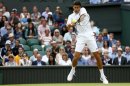 Novak Djokovic of Serbia hits a return to Jeremy Chardy of France in their men's singles tennis match at the Wimbledon Tennis Championships, in London