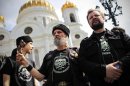 Members of an Orthodox militant group stand in line in front of the Moscow's Christ the Savior Cathedral to prevent access of opposition activists to the Cathedral in Moscow, Sunday, April 29, 2012. Opposition activists planned to pray to Holy Mother to deliver Russia from Vladimir Putin. They planned to repeat the 