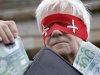 A man wears a blindfold designed like a flag of Switzerland during a demonstration against a Swiss-German tax amnesty agreement in Berlin, Germany, Wednesday, Aug. 10, 2011. (AP Photo/Michael Sohn)