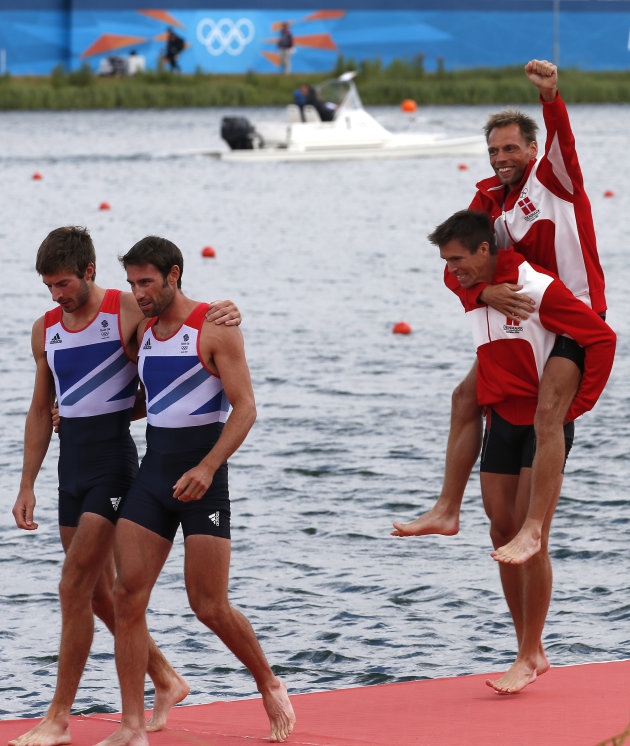 Gold medallists Rasmussen and Quist of Denmark celebrate next to silver medallists Purchase and Hunter of Britain after competing in the men&#39;s lightweight double sculls final during the London 201