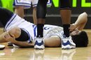 Minnesota Timberwolves' Ricky Rubio, of Spain, holds his left knee after he went down in a collision with Los Angeles Lakers' Kobe Bryant in the second half of an NBA basketball game on Friday, March 9, 2012, in Minneapolis. The Lakers won 105-102. Rubio was called for a foul on the play and had to be helped to the bench. (AP Photo/ Jim Mone)