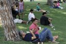 People gather in the shade at Belvedere Lake Park during heat wave grips in Los Angeles
