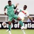 Uche Kalu of Nigeria challenges Tchomogo of Benin during their African Nations Cup soccer match at Ombaka stadium in Benguela