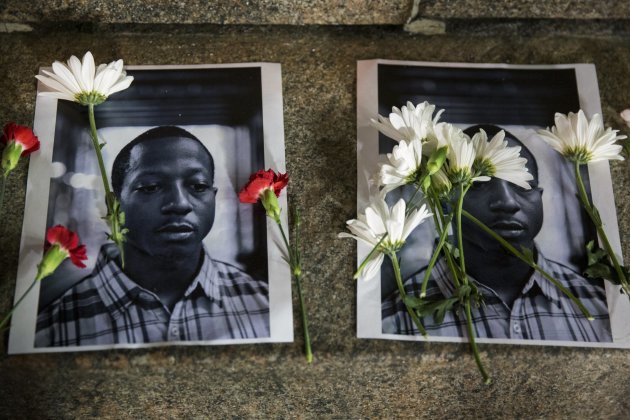 Flowers rest on top of pictures of Kalief Browder in New York June 11, 2015. New York City Mayor Bill de Blasio on Monday vowed to push reforms at the...