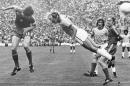 FILE - In this July 6, 1974 file photo, Deyna of Poland, left, heads the ball, while Brazil's Marinho challenges. Poland's Grzegorz Lato looks on, at right, during third place play-off in Munich, West Germany. On this day: Poland beats Brazil 1-0 to claim third place in the 1974 World Cup with Lato scoring the only goal, taking his tournament tally to 7. (AP Photo/File)