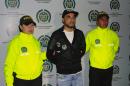 Picture by the Colombian police of Peruvian drug traffiker Gerson Galvez, aka Caracol (C), as he is escorted by the narcotics police at the Bogota airport on May 1, 2016
