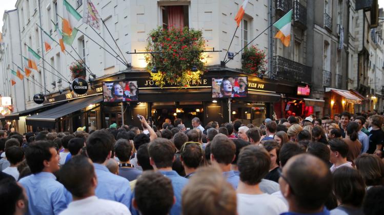 France team soccer fans gather in the street to watch a live broadcast of the 2014 World Cup Group E soccer match between Ecuador and France at the Maracana stadium in Rio de Janeiro, in Nantes