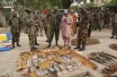 Military officials stand near ammunitions seized from suspected members of Hezbollah after a raid of a building in Nigeria's northern city of Kano