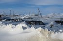In this photo taken March 15, 2012 cars are buried by snow near a residential area of Nome, Alaska. (AP Photo/Mark Thiessen)